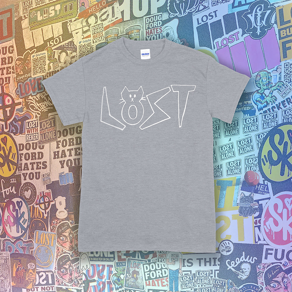Charlottes White Cat Letters. Hand drawn design of cat shaped letters. Drawn by my daughter Charlotte, and printed with white ink on a grey cotton shirt. Graffiti stickers in the background.