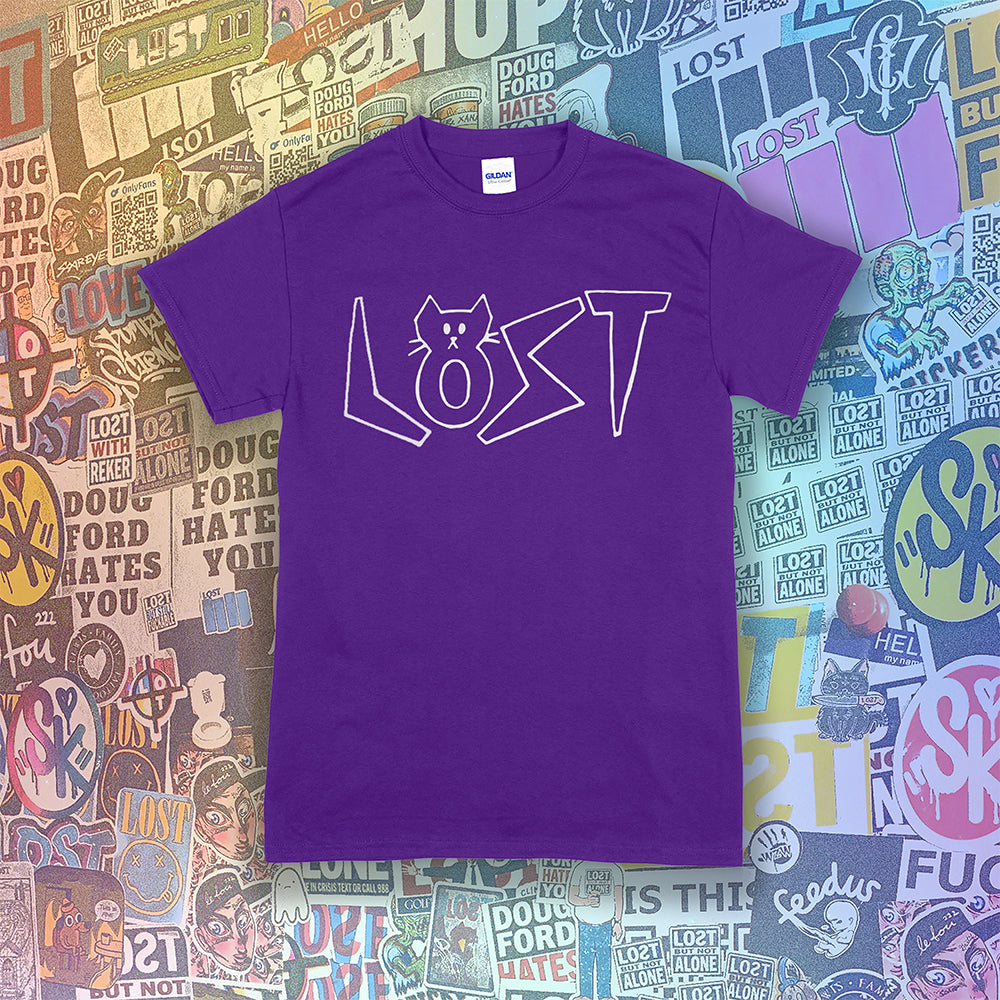 Charlottes White Cat Letters. Hand drawn design of cat shaped letters. Drawn by my daughter Charlotte, and printed with white ink on a purple cotton shirt. Graffiti stickers in the background.