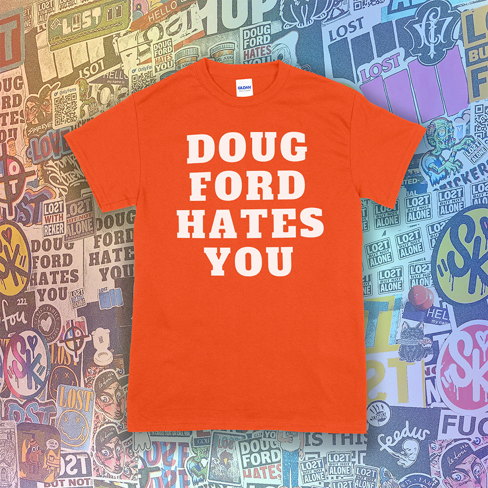 The original Doug Ford Hates You t-shirt. Bold white letters screen printed on an orange shirt. Colorful graffiti stickers make up the background.