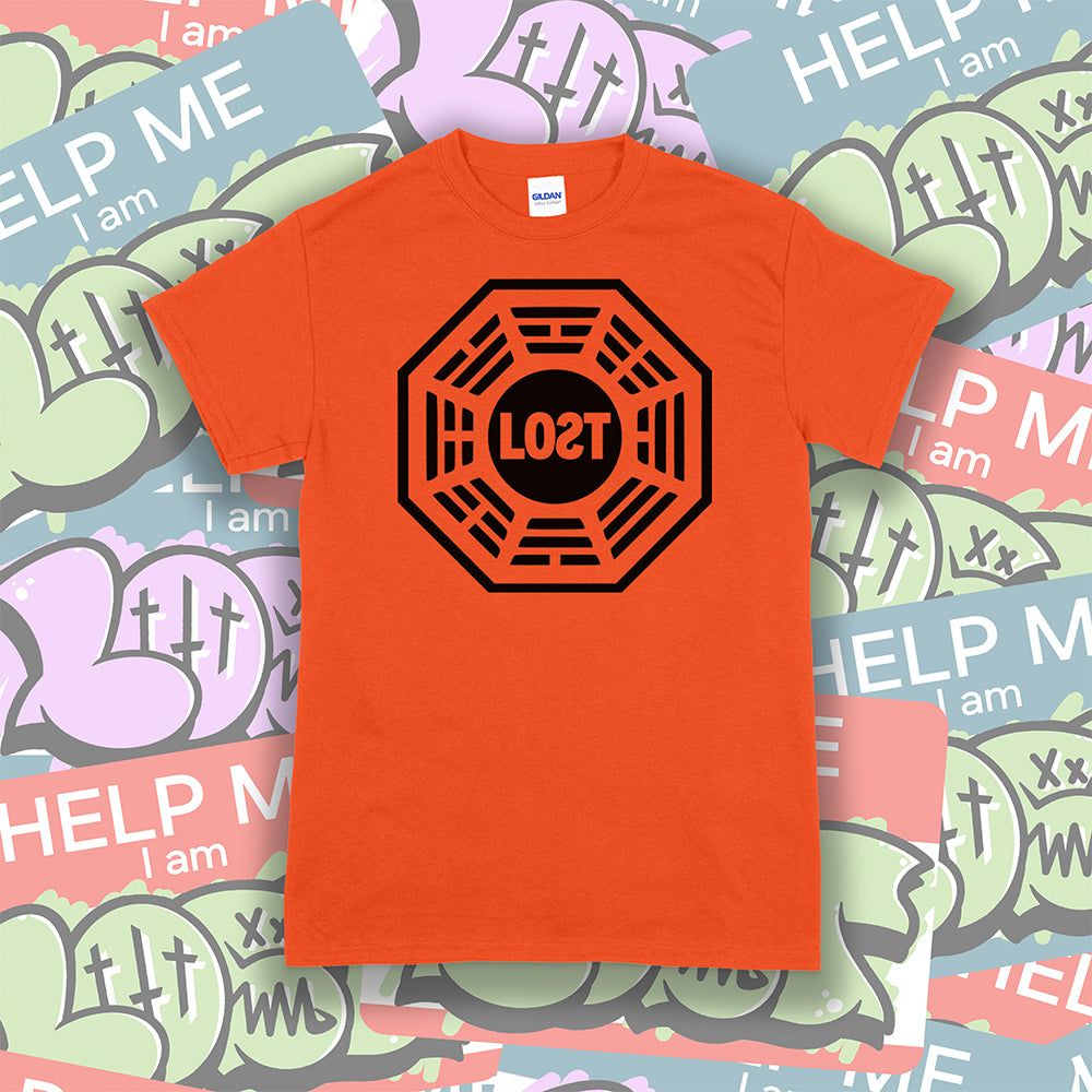 The Lost Initiative t-shirt by Lost Streetwear. The bold black logo is screen printed on bright orange shirt. A wall of brightly colored graffiti stickers make up the background.