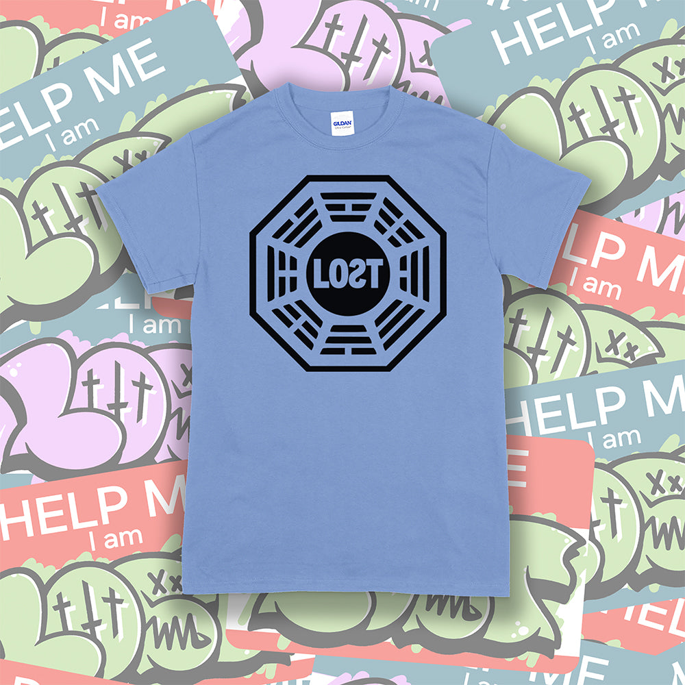The Lost Initiative t-shirt by Lost Streetwear. The bold black logo is screen printed on a Carolina blue shirt. A wall of brightly colored graffiti stickers make up the background.