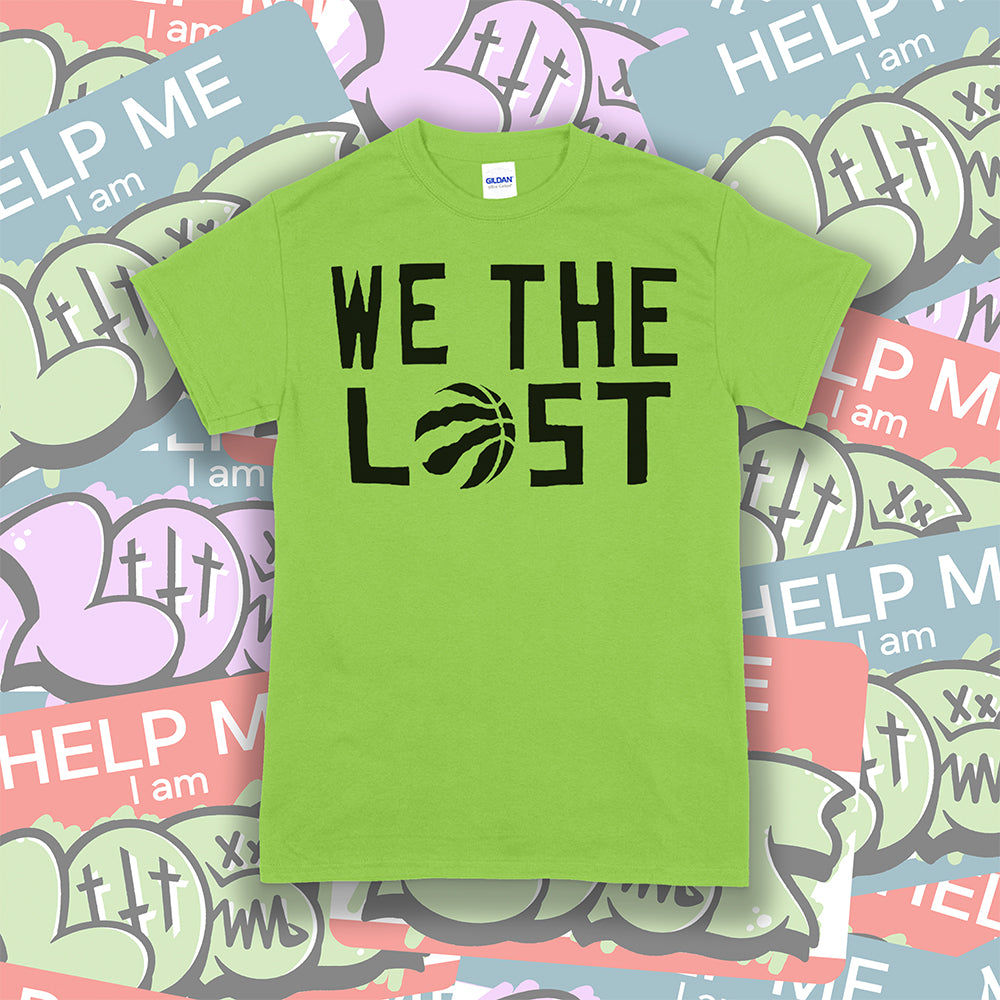 We The Lost t-shirt. Bold black lettering screen printed on a bright green shirt. Assorted colorful graffiti stickers make up the background.