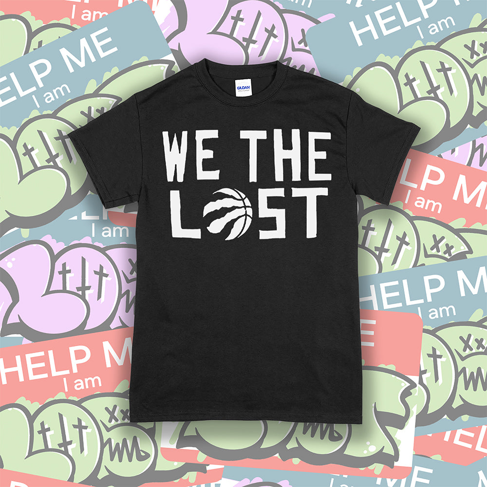 The We The Lost t-shirt. Bold white lettering and raptor claw design screen printed onto a black colored shirt. A collection of brightly colored graffiti stickers makes up the background.
